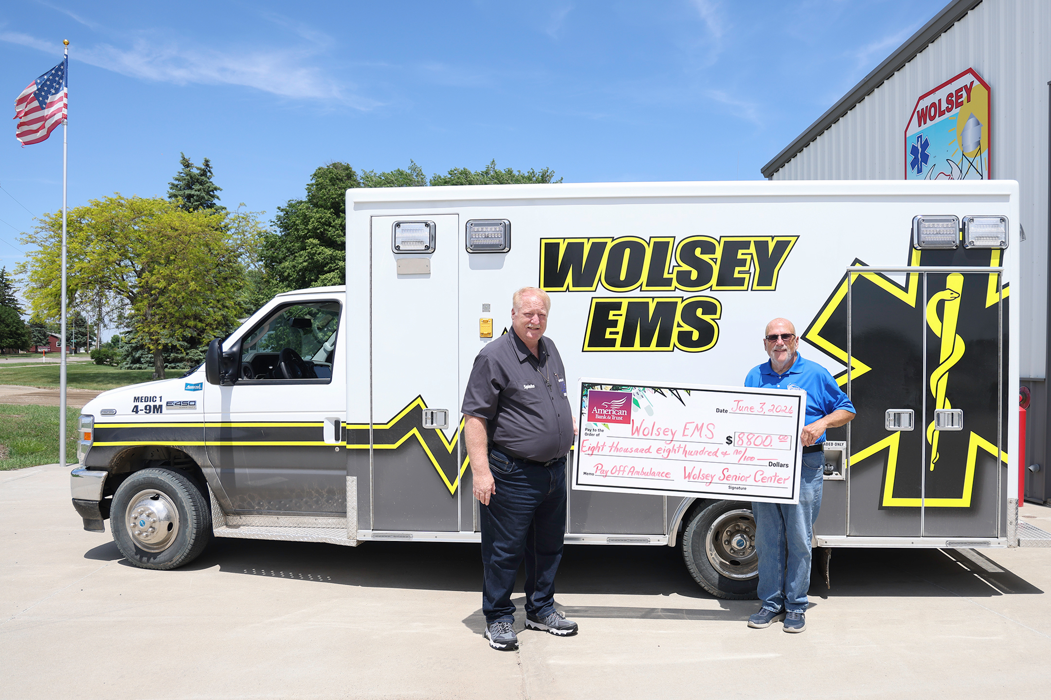 Wolsey Senior Citizen Center Incorporated board member Dave Burnison, right, presents an $8,800 check to Wolsey EMS Director Scott Spiehs at the Wolsey Fire Hall. The donation retired the remaining balance on the community’s ambulance, helping pay off approximately $170,000 in debt in just two years through community fundraising efforts, donations and grants. (KRISTI HINE/TRUE DAKOTAN)