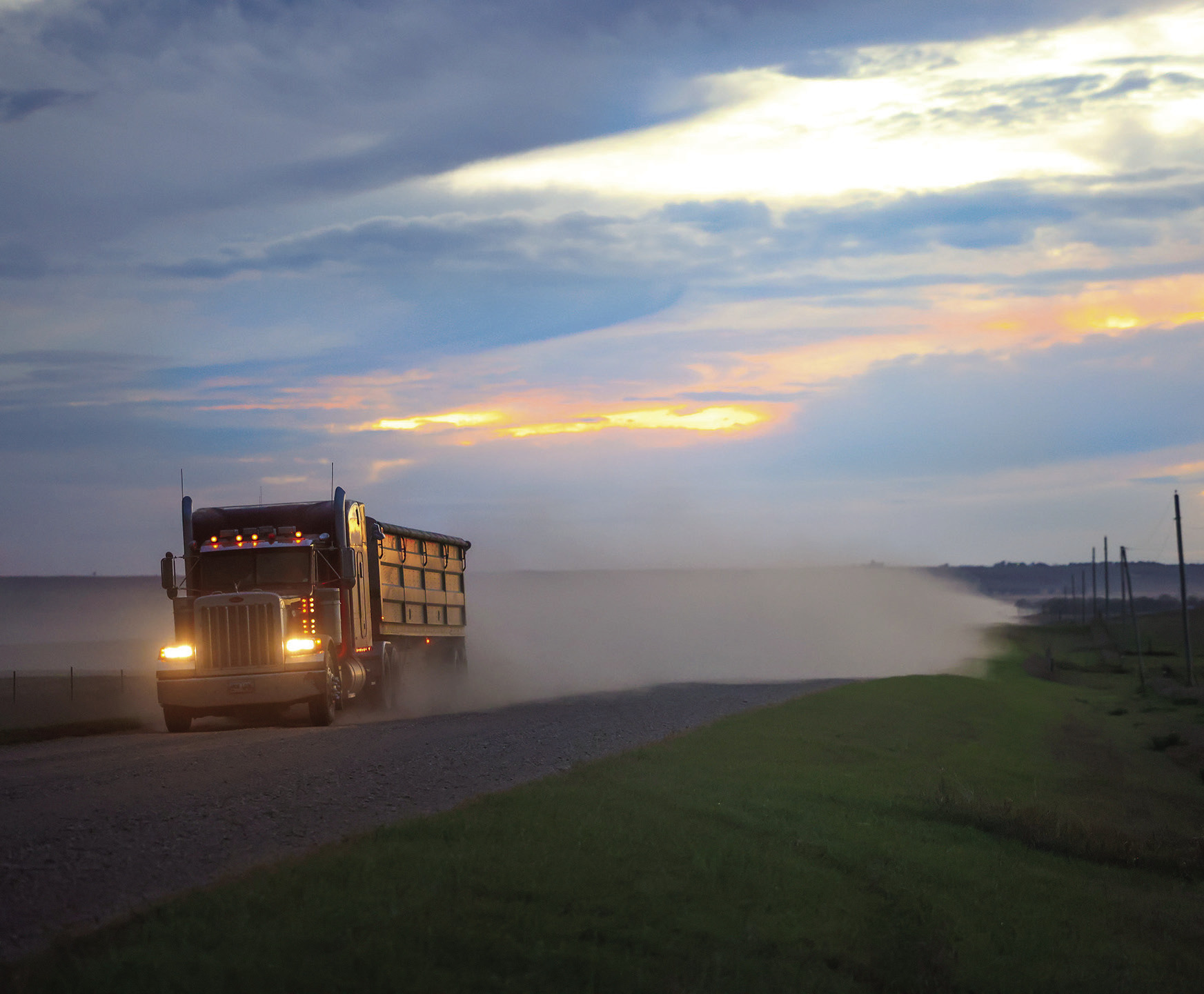 ABOVE: A semi hauling grain travels east along 221st Street, a major route for harvest traffic through Jerauld County. (TRUE DAKOTAN FILE PHOTO) LEFT: Newly installed signs mark the new 40 mph speed limit along 221st Street. (PHOTO COURTESY JERAULD COUNTY SHERIFF’S OFFICE)