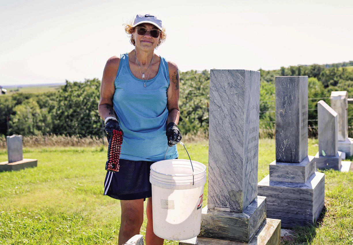 Sandy Jones carefully scrubs years of moss and lichen from a headstone at Prospect Hill Cemetery in Wessington Springs. Jones began cleaning the cemetery’s aging markers last summer and has devoted more than 40 hours to the volunteer project this year.