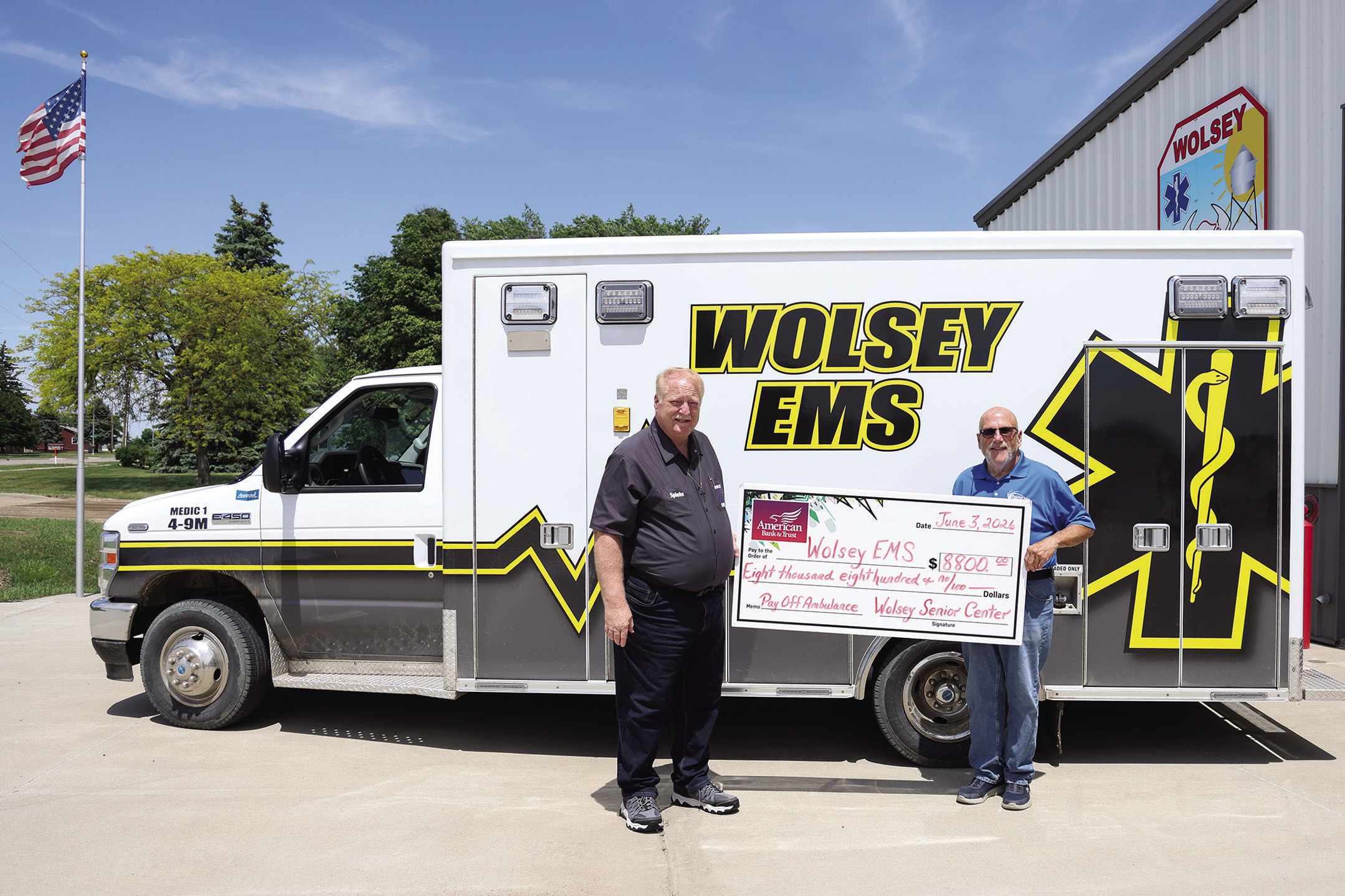 Wolsey Senior Citizen Center Incorporated board member Dave Burnison, right, presents an $8,800 check to Wolsey EMS Director Scott Spiehs at the Wolsey Fire Hall. The donation retired the remaining balance on the community’s ambulance, helping pay off approximately $170,000 in debt in just two years through community fundraising efforts, donations and grants. (KRISTI HINE/TRUE DAKOTAN)