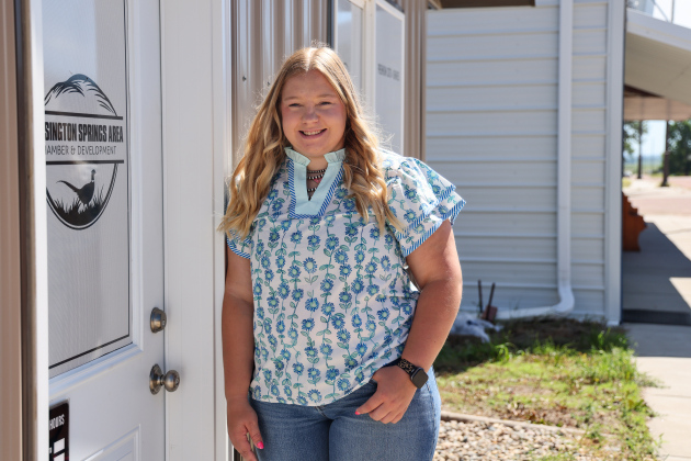 Lilli Steeke, executive secretary and community liaison for the Wessington Springs Area Chamber and Development Corporation, stands outside the organization's Main Street office. Steeke began her role May 11 and supports the WSACD board through event planning, communications, social media and community outreach. (KRISTI HINE / TRUE DAKOTAN)
