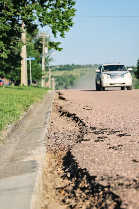 Washouts are visible along the curb and gutter on the recently installed surface of Second Street north of Our Savior's Lutheran Church. City officials have declined to accept substantial completion of the project while awaiting a repair plan from H&W Contracting. (KRISTI HINE / TRUE DAKOTAN)