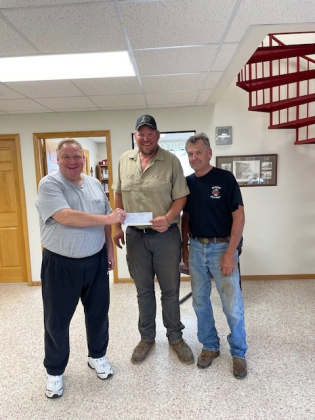 Check presentation to the Alpena Fire Department’s Volunteer Fireman Chris Albrecht, center, receiving the check, (over $2700) with Volunteer Fireman Bruce Orth, right and Todd Boomer, left. (COURTESY PHOTO)