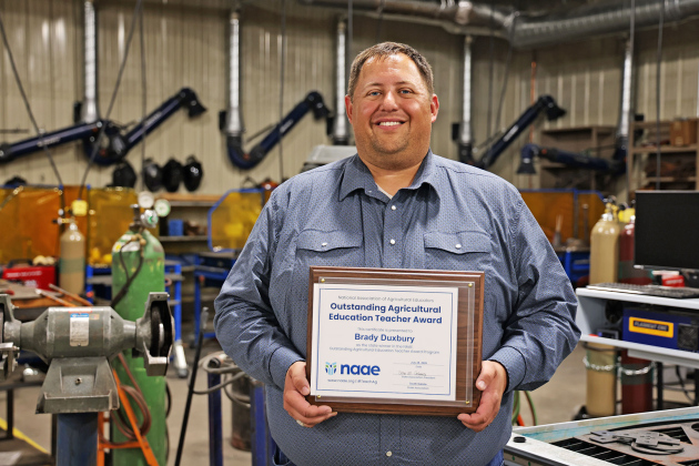 Wessington Springs agriculture education teacher Brady Duxbury displays his Outstanding Agricultural Education Teacher Award in the Wessington Springs High School ag shop. Duxbury was named South Dakota’s winner before advancing to earn the Region III honor and will represent agriculture educators from six Midwestern states at the National Association of Agricultural Educators convention in New Orleans in December. (KRISTI HINE / TRUE DAKOTAN)