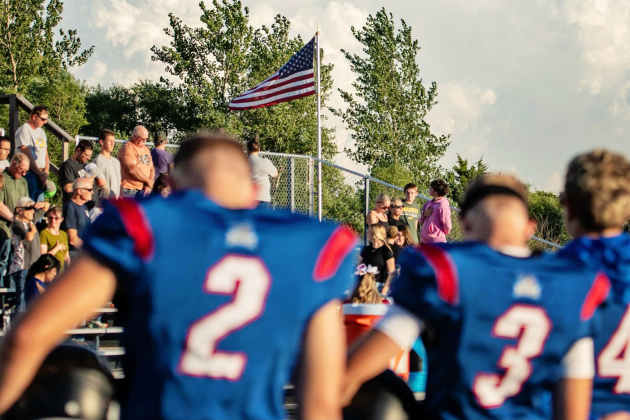 Bucks players line up with the American flag flying beyond the field during their Sept. 11 game against Mobridge-Pollock in Forestburg. A moment of silence was held before the game in remembrance of the victims of the Sept. 11, 2001, terrorist attacks, 25 years after the attacks. (PHOTO COURTESY J. VON EYE IMAGES)
