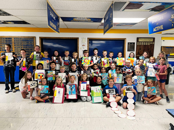 CLEANING HOUSE AT THE STATE FAIR. More than 30 Wessington Springs Elementary students in grades K-6 proudly show off the artwork and ribbons they earned at the South Dakota State Fair. The young artists gathered in the elementary lunchroom for a group photo celebrating an impressive showing at this year’s fair. (PHOTO COURTESY LEXI JOHNSEN)