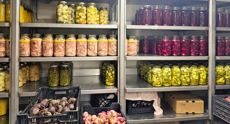 Pickled and preserved vegetables in a storage room at Spring Valley Colony, pictured July 17, 2026. (PHOTO: ELENA TITTEL/SD NEWS WATCH)