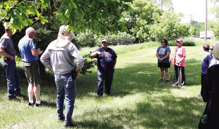 Wessington Springs High School Vo-Ag instructor Brady Duxbury points out identifying characteristics of trees during “A Walk in the Park” on May 31 in Wessington Springs City Park.