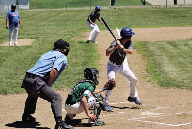 TOP: Dylan Schimke bats with Brock Krueger at third base during Sunday’s doubleheader against Chamberlain. Schimke drove in five runs across the two games as the Owls swept the Mallards. ABOVE: Springs Owl pitcher Bubba Peterson delivers a pitch during a first game doubleheader in Springs on Sunday. Despite 96 degree temperatures, Peterson pitched a six-inning 12-1 victory over the Chamberlain Mallards, striking out ten batters. (PHOTOS BY CRAIG WENZEL FOR THE TRUE DAKOTAN)