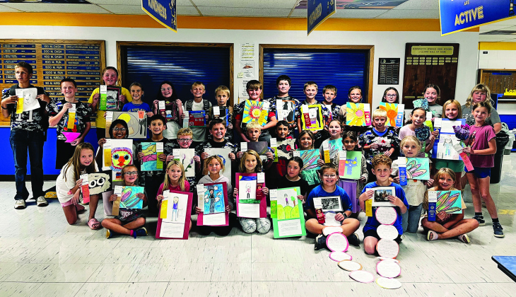 CLEANING HOUSE AT THE STATE FAIR. More than 30 Wessington Springs Elementary students in grades K-6 proudly show off the artwork and ribbons they earned at the South Dakota State Fair. The young artists gathered in the elementary lunchroom for a group photo celebrating an impressive showing at this year’s fair. (PHOTO COURTESY LEXI JOHNSEN)