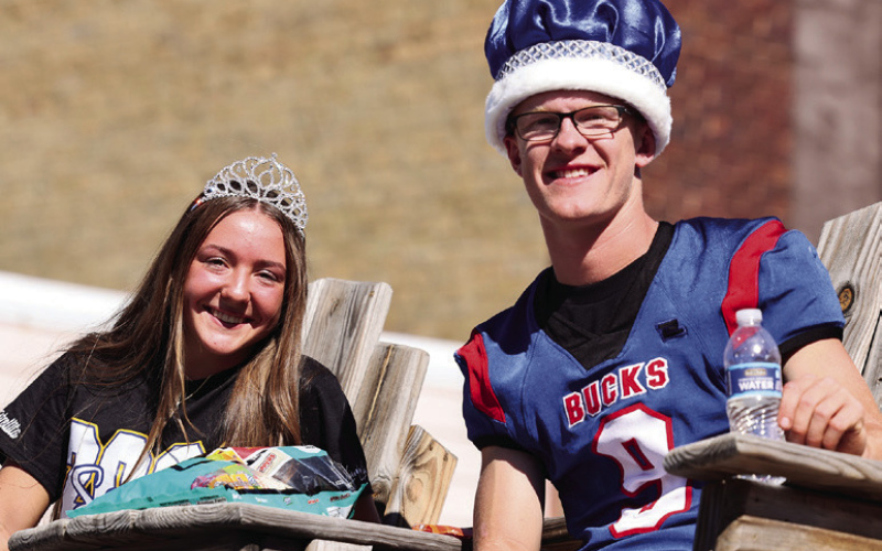 King Luke and Queen Logan wave from the senior float.
