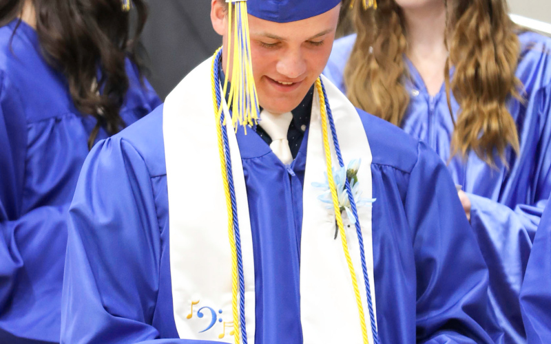 Graduate Kaden Wolter opens the envelope that keynote speaker and restaurateur Steve Grove gave to each of the graduating seniors. Much to their surprise, each envelope contained $500 cash and an assignment from Grove: “Do something for the people who have made an impact in your life — spend none on yourself. This is for you to thank others. Be thankful for those who have made yousuccessful, be grateful. If there is any left over, donate it to the Blue Bag Backpack Program.”
