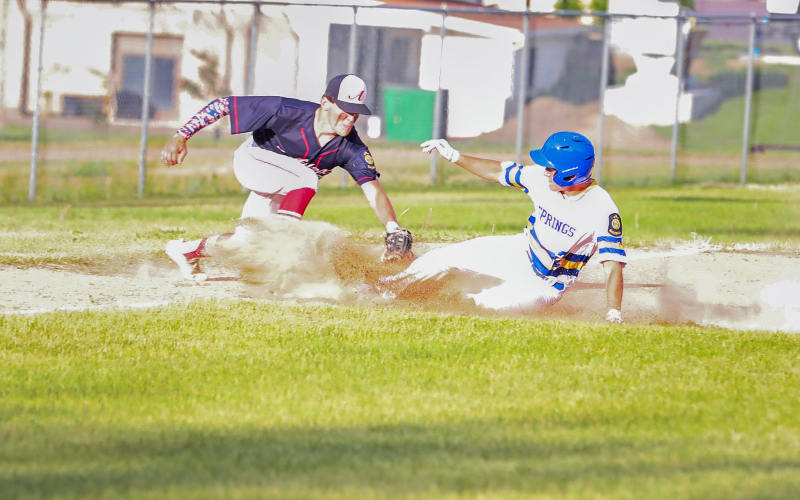 Shown sliding into third is Dylan Schimke.