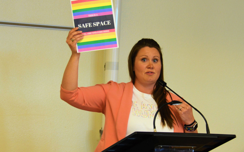 Lead-Deadwood Elementary School counselor Amanda Bender holds up a “Safe Space” sign during a recent school board meeting. The sign led to a proposed policy in the Lead-Deadwood schools that would regulate how teachers can decorate or adorn their classrooms. Photo: Courtesy Jaci Conrad Pearson, Black Hills Pioneer.