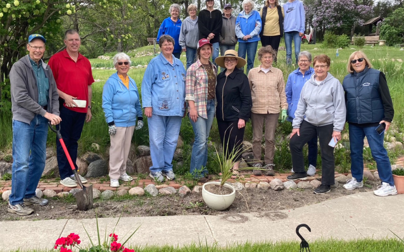 Shown in the front row after the blessing officiated by Pastor Mike Easter are: Gail Arnott, Pastor Mike Easter, Diane Winter, Ardell Johnson, Cheri Lopez, Susan Arnott, Kathy Dean, Michele Olsen, Brenda Deines and Jacquie Arnott. Back row, left to right: Jean Scheel, Terri Mebius, Holly Goehring (Fiegen), Jean Shultz, Betty Higgins, Patti Fiegen and Masynn Mebius.