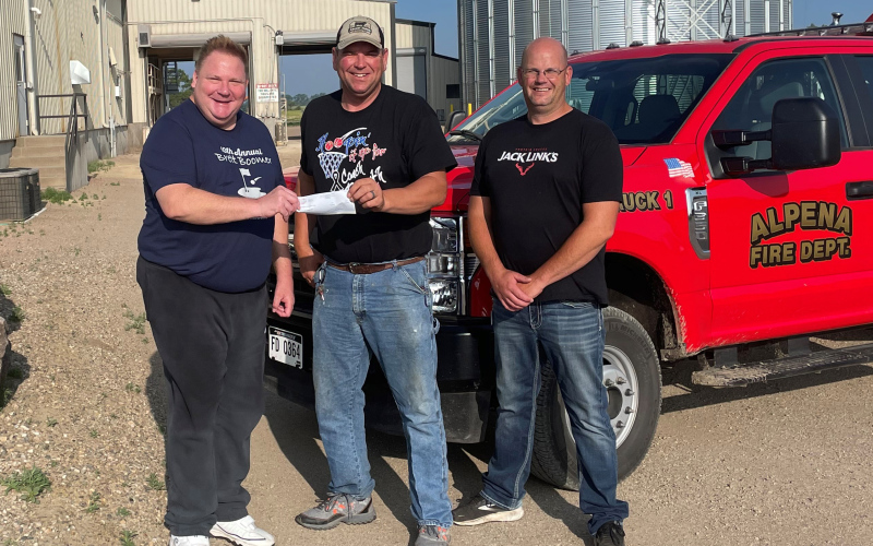 Funds raised from the event totaled nearly $4,000 and has been donated to the Alpena Volunteer Fire Department. Shown left to right are Todd Boomer, event organizer,  Alpena Fire Chief Gerry Orth and volunteer fireman Eric Siemonsma next to the fire department’s new brush truck.