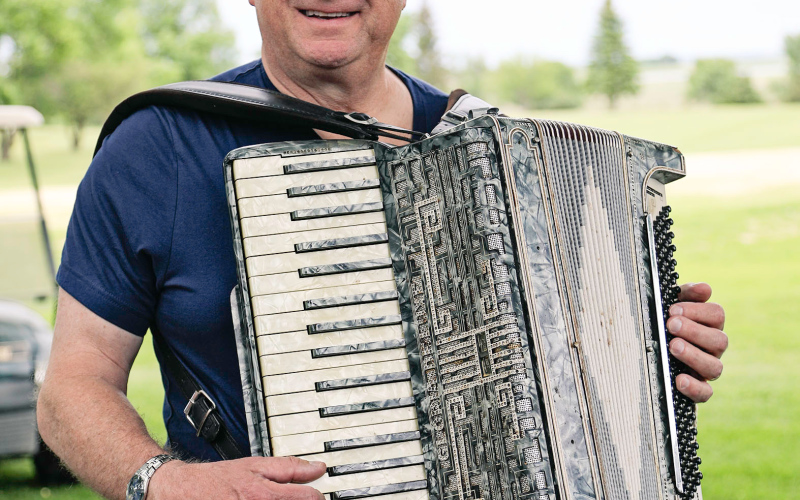 Bill Koncar played accordion on the patio behind the 9th green