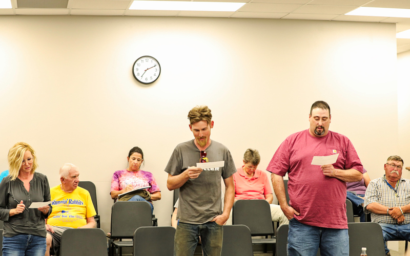 During the Monday, July 11 Wessington Springs School District Board of Education meeting, three recently elected school board members took their oaths of office, officially beginning their three-year terms. Shown above, left to right while reading their oaths of office are Sara Thompson, Derek Zastrow and Darrick Van Dyke. KRISTI HINE / TRUE DAKOTAN