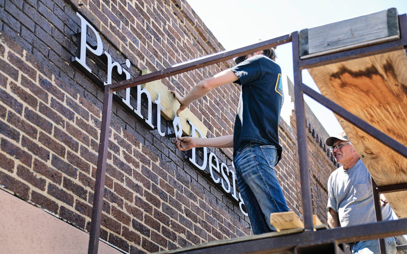 Save-the-day sign installers elevate True Dakotan's new look