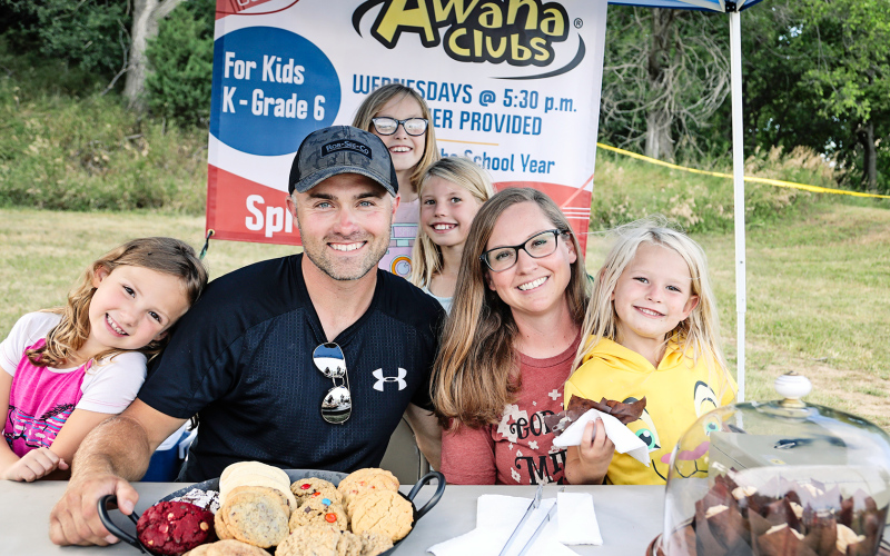 Josh and Natalie Bartel along with helpers (front) Emersyn Bartel and Ryklynn Reiner plus (back) Kenzie Bartel and Crawleigh Reiner sold cookies and sweet treats to help raise funds for the Awana youth program.