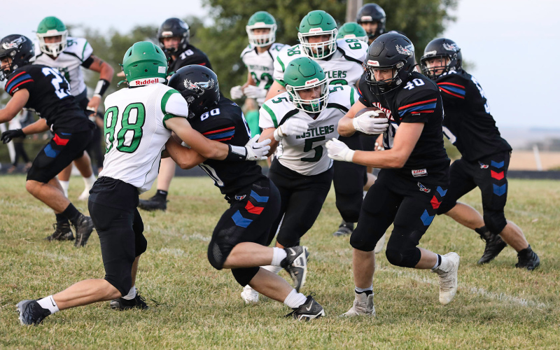 Carter Gaikowski (60) creates a path for Camden Jost to carry the ball down the field. Jost ran for 79 yards in the game.