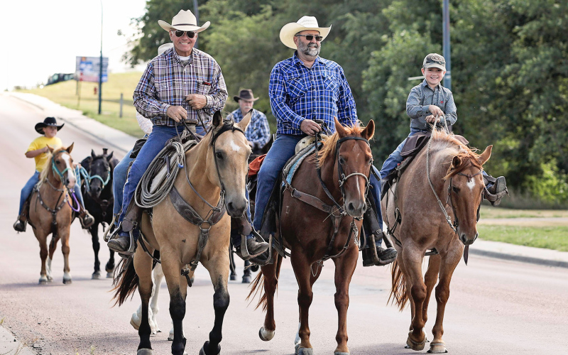 Randy Kieser, Bob Hine and grandson Dawson Bultsma ride down Dakota Avenue to finish this year’s Kyle Evans Memorial Wagon Train. KRISTI HINE / TRUE DAKOTAN
