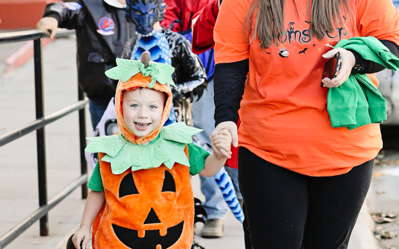 KaeLynn Culver and sons Landon (pictured in his pumpkin costume) Gannon and Caleb are shown making their way east on Main in search of goodies before continuing on through town for a night of trick-or-treat fun.