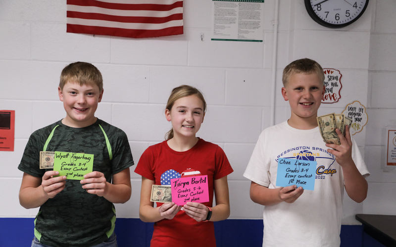 Shown left to right are essay contest winners Wyatt Fagerhaug, Taryn Bartel and Chaz Larson.