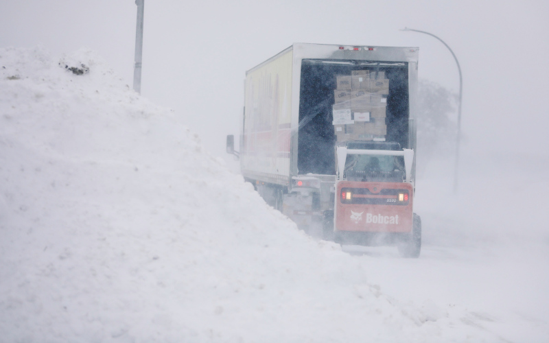 While most grocery shoppers were hunkered down at home in the Jerauld County area, grocery store owner Ryan Jensen along with mom Peggi and son Sutten held down the fort, taking delivery on Thursday in the midst of blustery conditions last Thursday KRISTI HINE / TRUE DAKOTAN