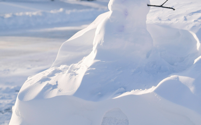 In between winter storm events, Paige Clover built a snowman on the snow-covered trunk of her car parked along Main Street in Springs.