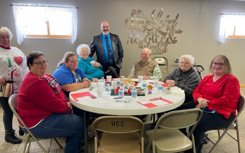 Katelin Deneke, sitting at the table to the right told event organizers that her reason for coming was the two empty places at the table this year — those of her dad and grandpa. She thanked the organizers for doing this for her grandma, with whom Katelin attended.