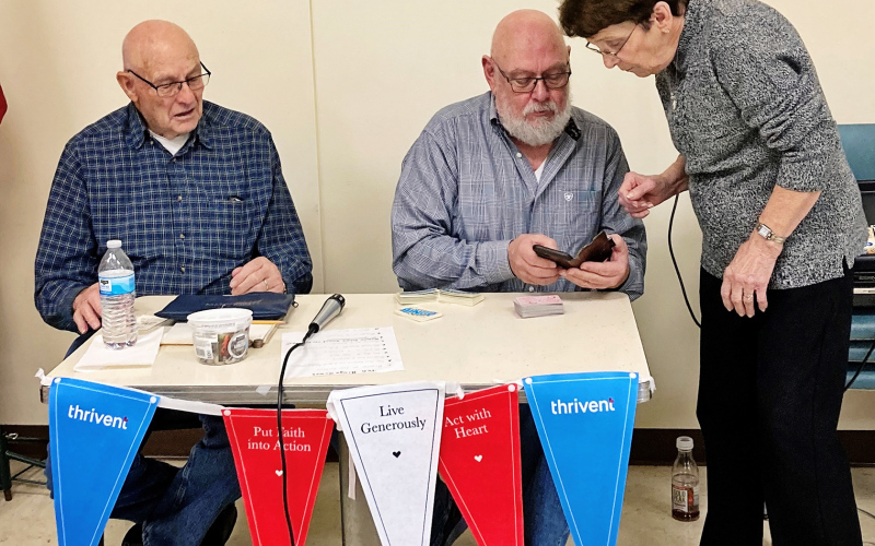 yle Pawlowski showed Tim Holzwarth how to call the numbers for the bingo games with assistance from Shirley Bender and Cathy Holzwarth (not pictured).