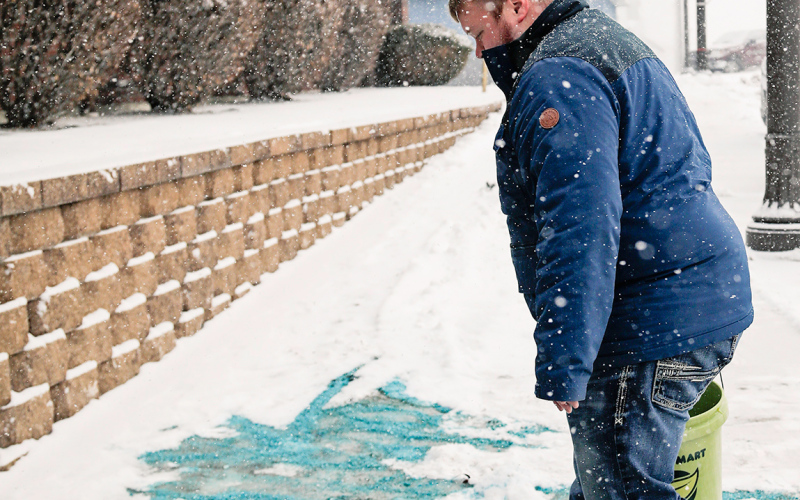 Blake Willman could be seen scooping and spreading salt in front of American Bank and Trust once again last week as the area was doused with a wintry mix.