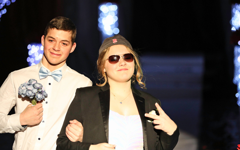 During round two of Grand March, Alicia Collins donned the jacket of escort Peyton Walz, a good trade for her bouquet.