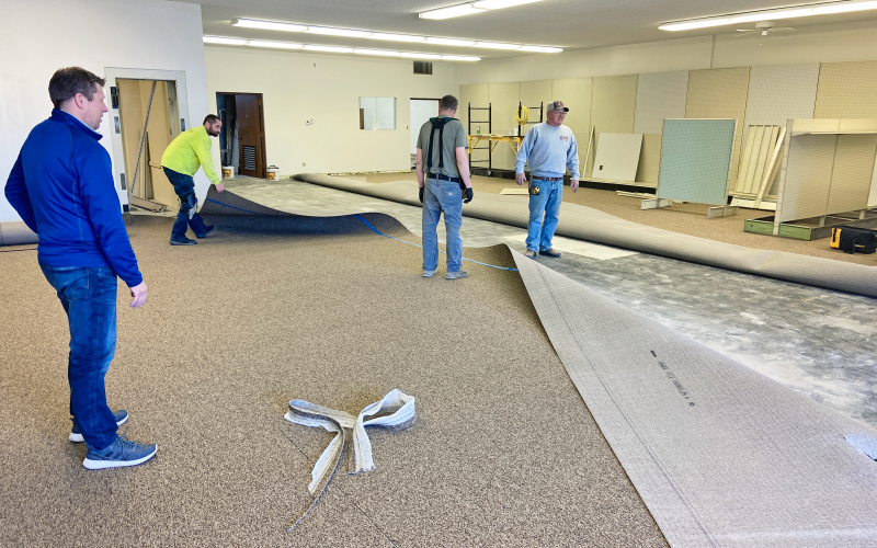 Ryan Jensen oversees carpet installation in the new location of Jensen's.