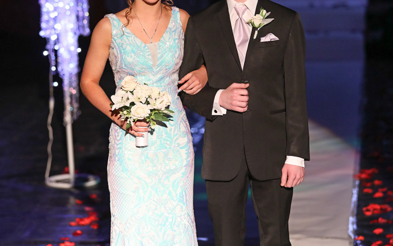 Logan Mohling is escorted by Tregen Jensen.