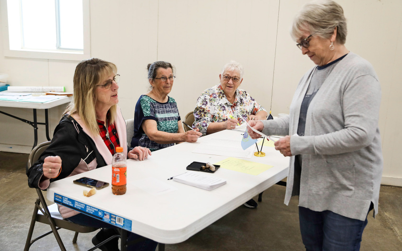Poll workers Cindy Rounds, Jean Ferguson and Pam Hainy help check in Wessington Springs School District voter Marcella Andersen at the Jerauld County Ag Building Tuesday, April 11.