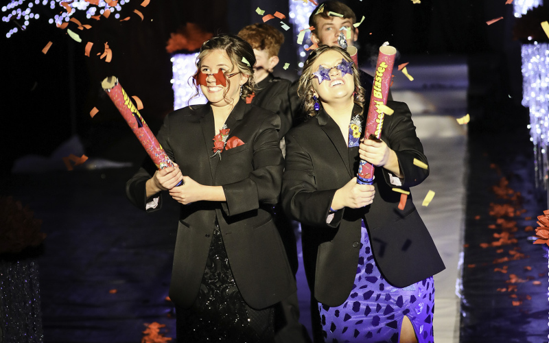 Jada Kolousek (left ) and Mercedes Jones blast the front few rows of spectators with a dizzying display of confetti. Jones was escorted by Heyns Bothma and Kolousek was escorted by JD Thompson.