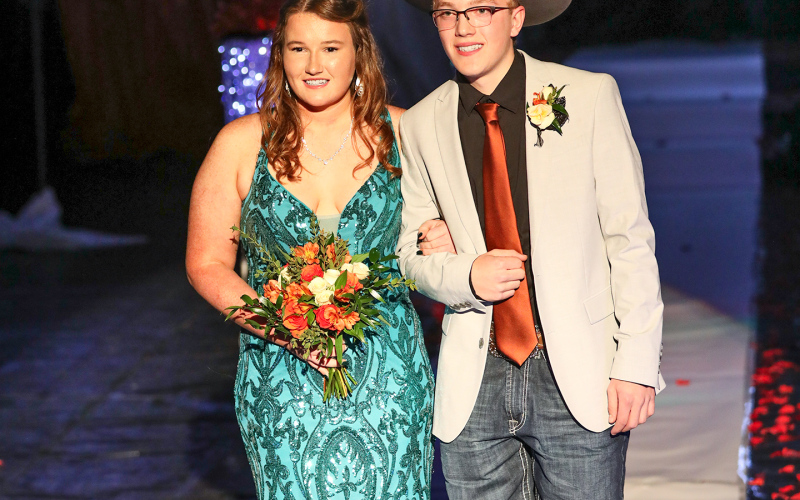 Riley Roduner is escorted by Chance Blum.