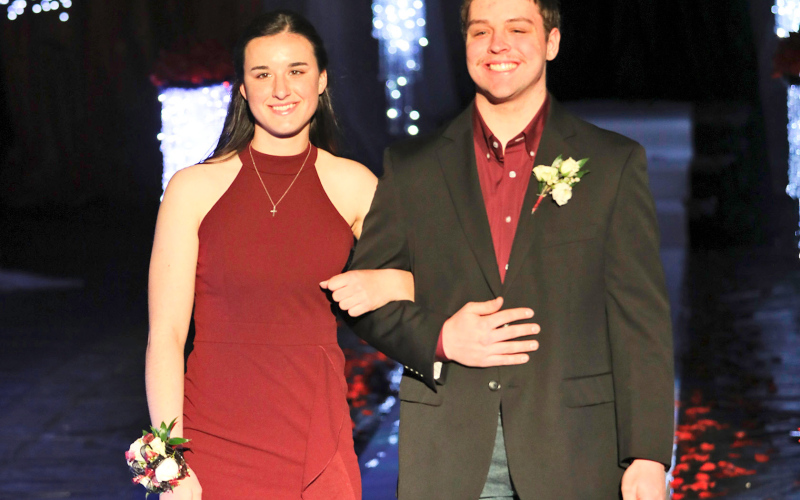 Carson Hainy escorts Sarah Poncelow.