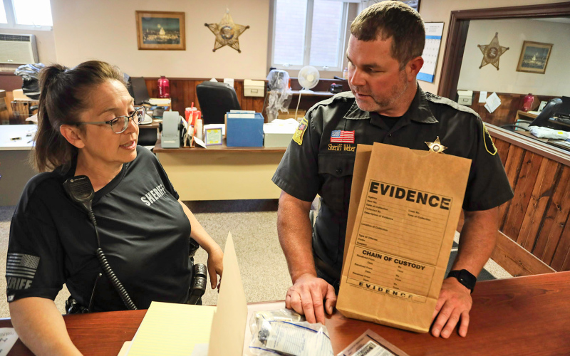 Jerauld County Sheriff's Deputy Dawn Lake, and Sheriff Jason Weber, review evidence from last week's string of auto burglaries.