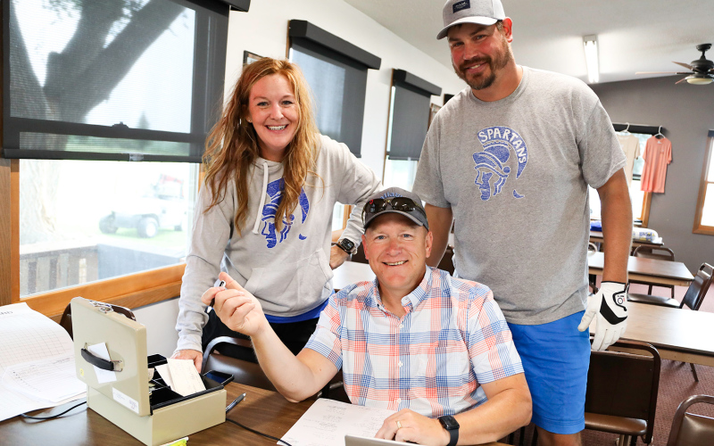 A large tournament like the Blue &amp; Gold relies on help from many volunteers. Tourney helpers shown above are Regina Teveldal, Jason Kolousek and Brian Amick.