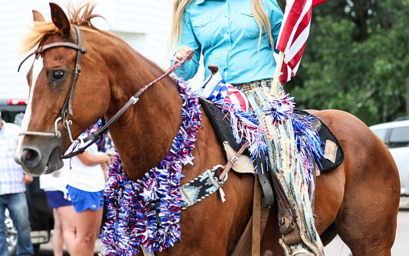 Coming straight from the barrel race held the morning of July 4 Lilliya Meek carried Old Glory along the parade route.