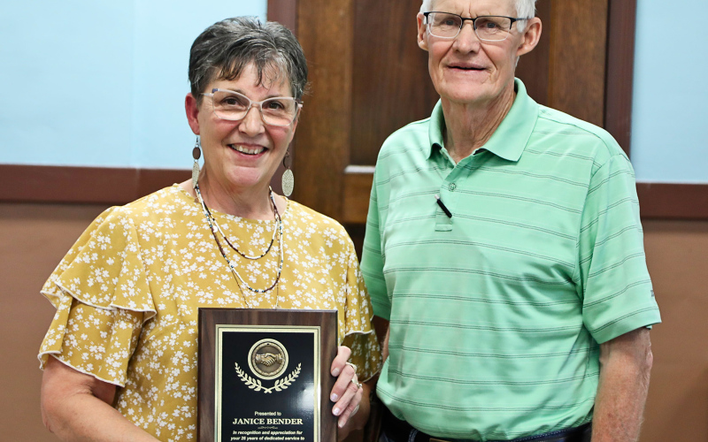 Janice Bender (left) was recognized at a retirement ceremony at the courthouse last month for her 26 years of employment with Jerauld County. She is shown holding a plaque of recognition and appreciation with Jerauld County Commissioner Charlie Bergeleen.