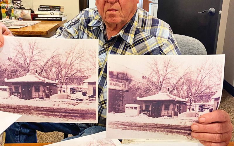Wessington Springs man Fred Knight holds photos of the pagoda gas station, just two pieces among stacks of research he’s conducted on the building’s history over the years.