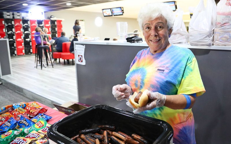 Springs Food Market and Pin Twisters teamed up for free hot dogs and open bowling lanes. Esther Walker is shown serving.