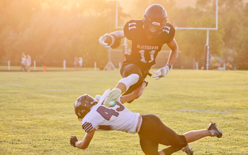 Ryder Michalek (11) evades a tackle in a show of athleticism during Friday’s Blackhawks game vs. the Mt. Vernon / Plankinton Titans. The Blackhawks came out on top in the 2023 season’s first game with a 36-8 victory.