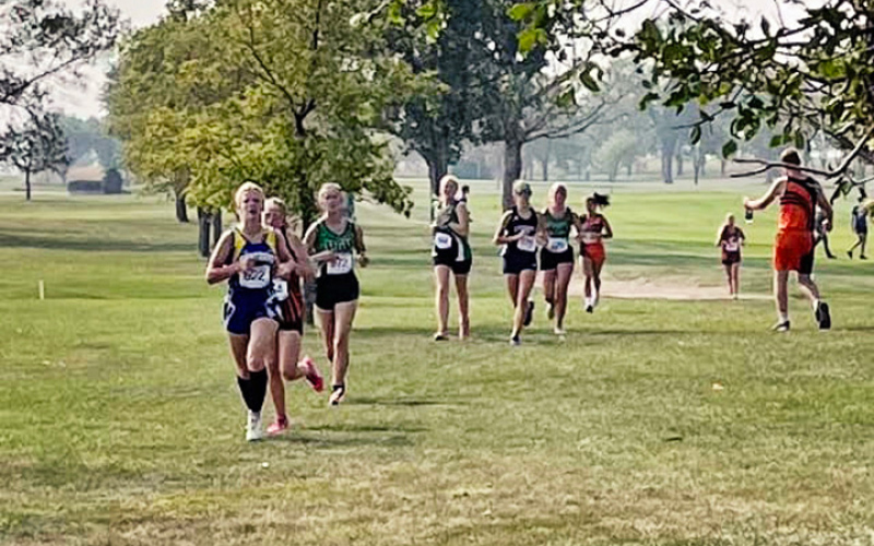 Freshman, Ella Kolousek (pictured at the front of the pack above)  finished the race in 27:45.34.
