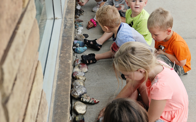 Tiny tots from Chelsea Waters’s Daycare took a near-daily walk about Main Street with the daycare owner. They are shown above visiting “Cornell the Caterpillar” in front of Jensen’s. All summer long, the kids would watch in delight as the painted-rock caterpillar grew. Community members were asked to paint a rock and bring it back to Main Street so that Cornell could grow longer and longer throughout the summer.
