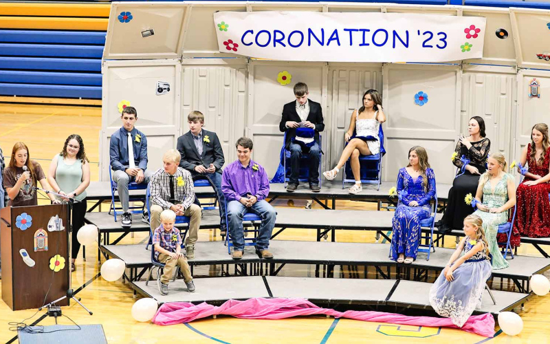 The royal court along with last year’s King Austin Schimke and Queen Kate Havlik are shown onstage (center) just before the crowning of this year’s royalty.